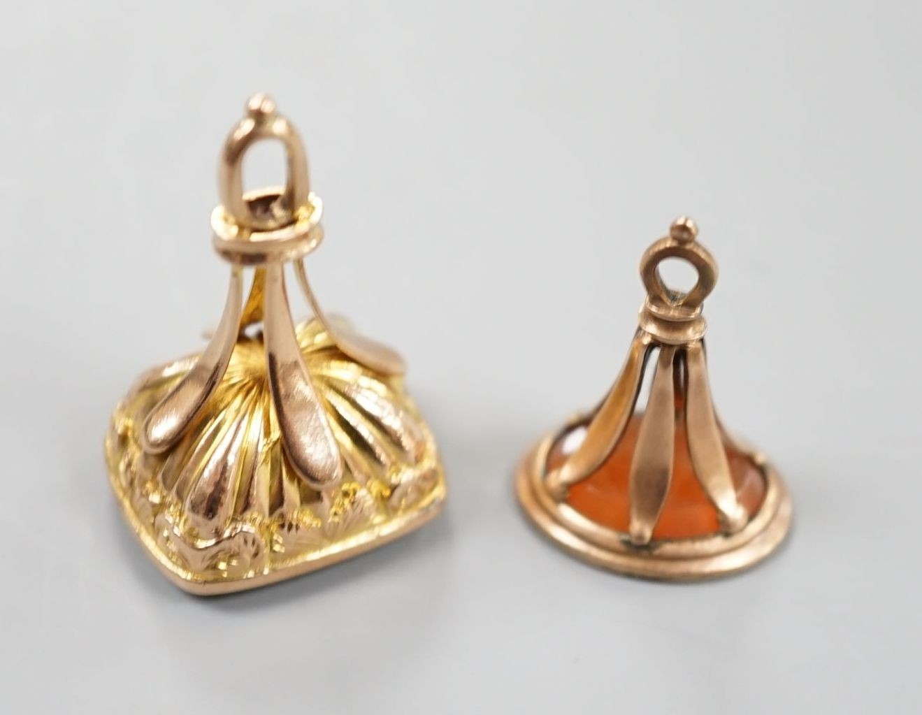 A late Victorian yellow metal and carnelian set fob seal, 23mm and a George V 9ct gold and bloodstone set fob seal.